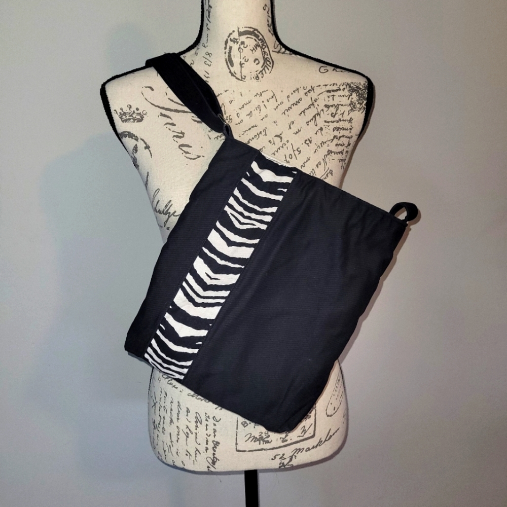 Black crossbody purse with zebra stripe.